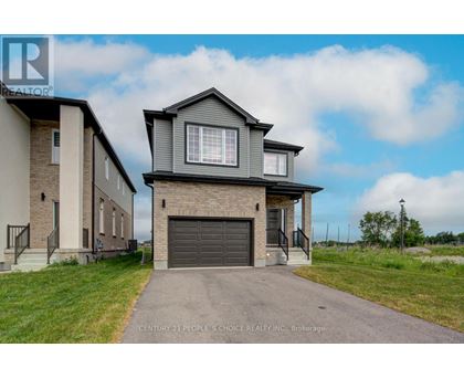 A house with a grey garage door is for sale.