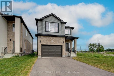 A house with a grey garage door is for sale.