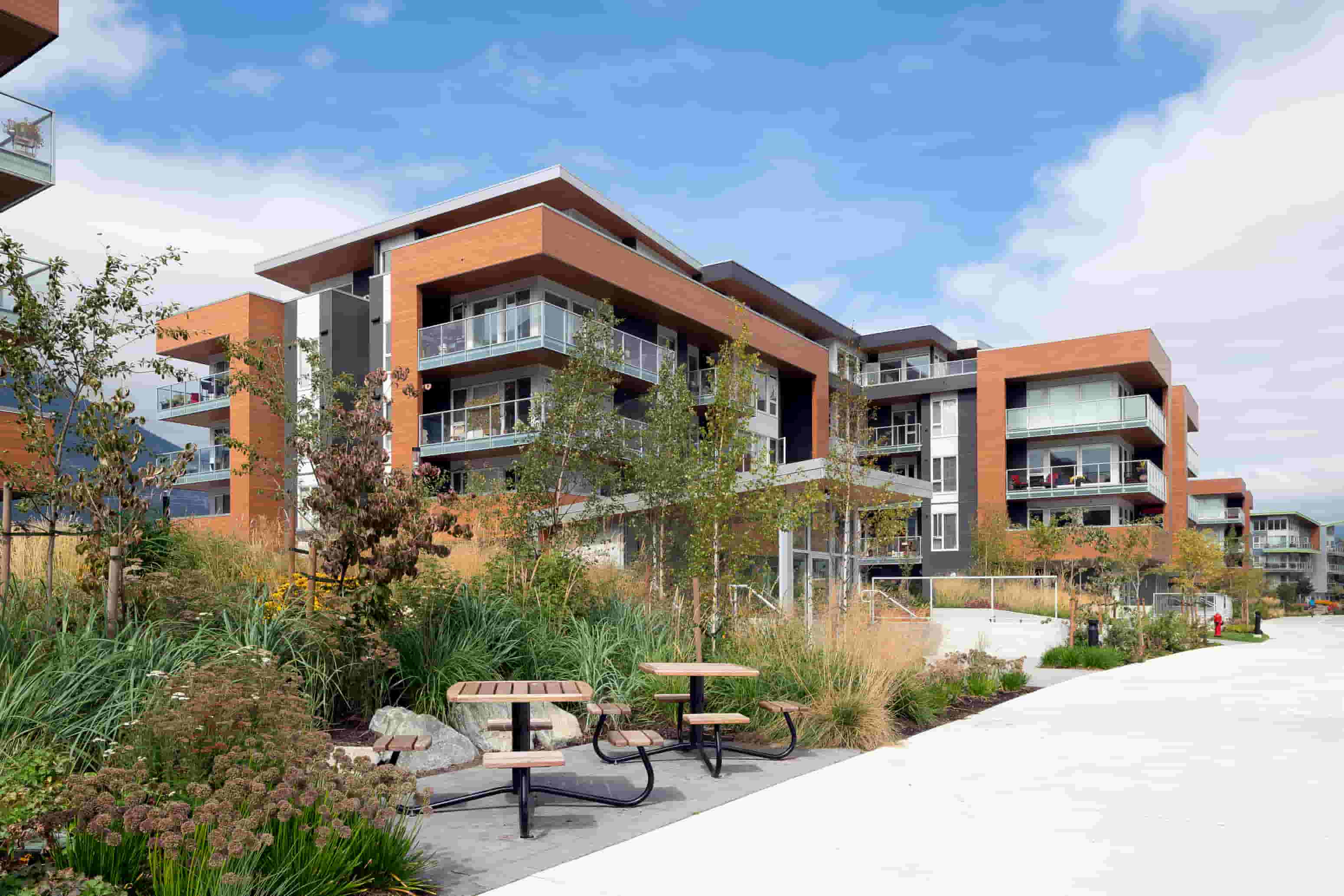 A modern building with a garden in front.