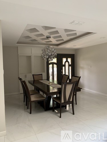 A dining room with a table set for four.