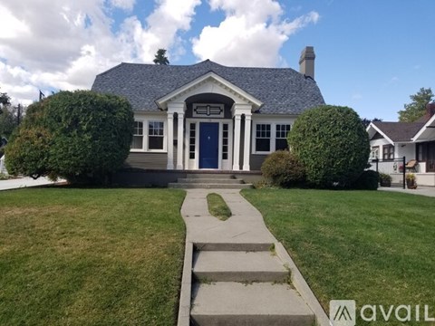 A house with a blue door and a white front porch.