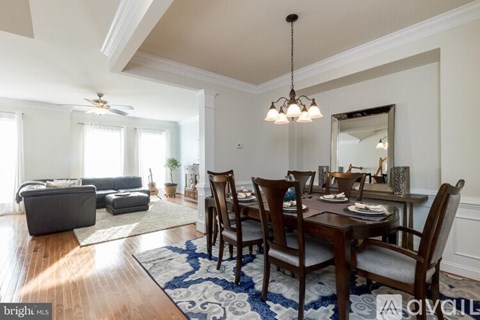 A dining room with a wooden table and chairs.