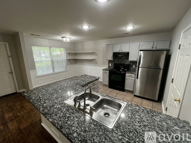 A kitchen with granite countertops and stainless steel appliances.