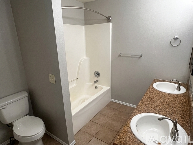 A white toilet is next to a bathtub in a bathroom.
