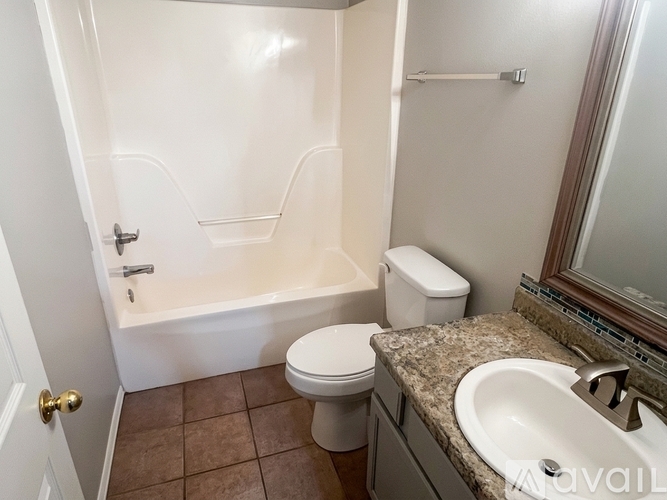 A bathroom with a toilet, sink, and bathtub.