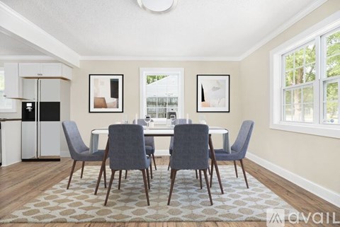 A dining room with a table set for four.