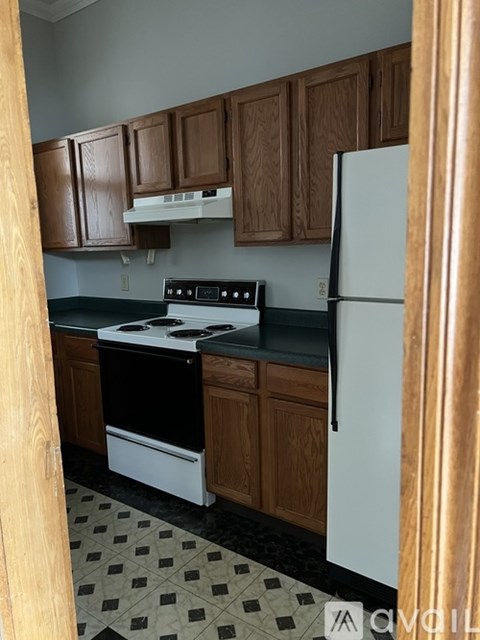 A kitchen with a black and white checkered floor.