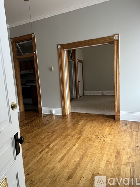 A room with wooden floors and a white door.