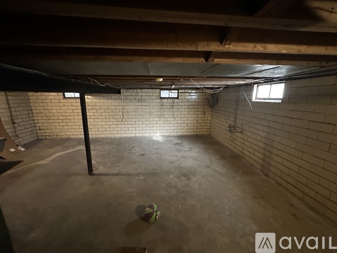 A room with a brick wall and a concrete floor.