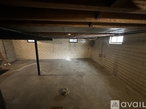 A room with a brick wall and a concrete floor.