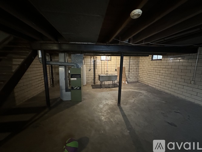 A room with a brick wall and a concrete floor.