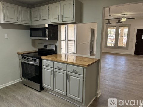 A kitchen with a wooden countertop and stainless steel appliances.