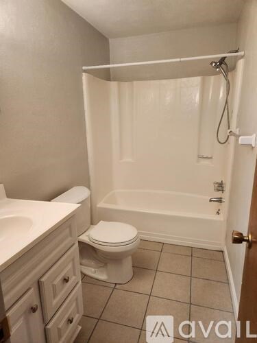 A bathroom with a toilet, sink, and bathtub.