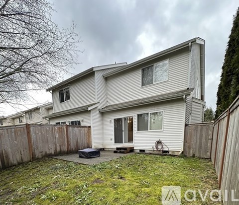 A house with a fence and a small backyard.