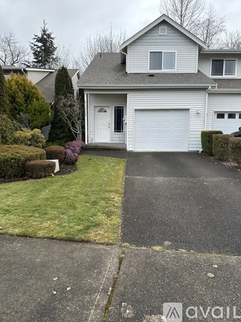 A house with a white garage door is for sale.