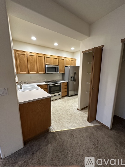 A kitchen with wooden cabinets and a white countertop.
