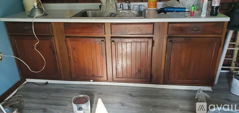 A kitchen with wooden cabinets is undergoing a renovation.
