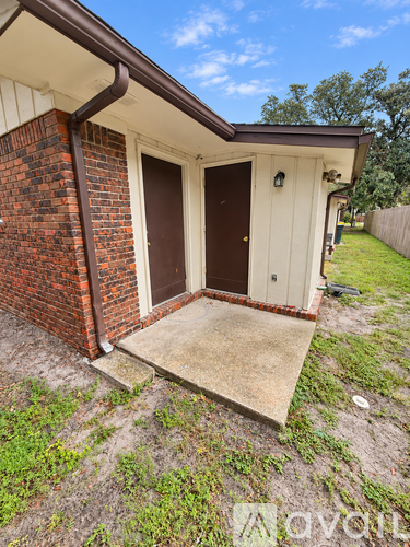 A small house with a brown door and a brown roof.