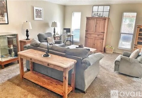 A living room with a wooden coffee table in the center.