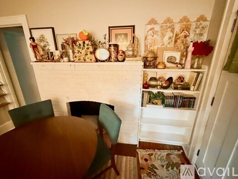 A dining room with a table and chairs.