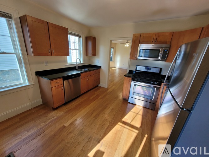 A kitchen with wooden cabinets and stainless steel appliances.