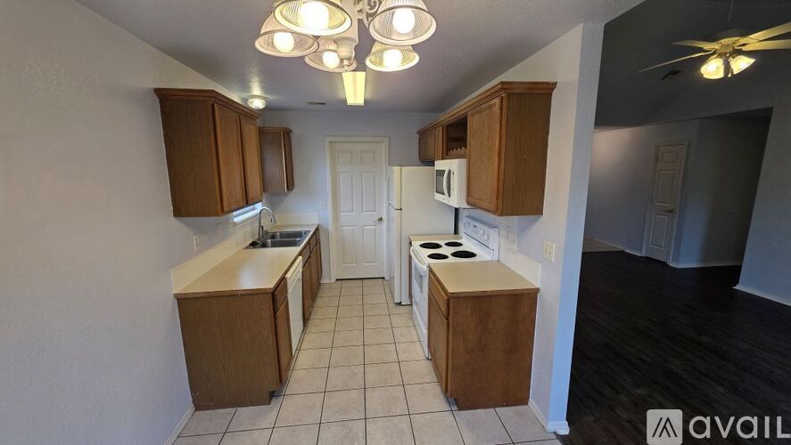 A kitchen with wooden cabinets and a white refrigerator.