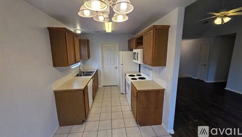 A kitchen with wooden cabinets and a white refrigerator.