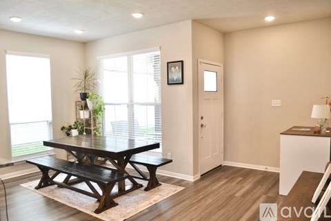 A dining room with a wooden table and benches.