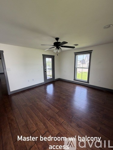 A room with a master bedroom and balcony access.