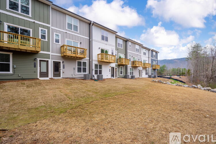 A row of multi-story apartment buildings with balconies.