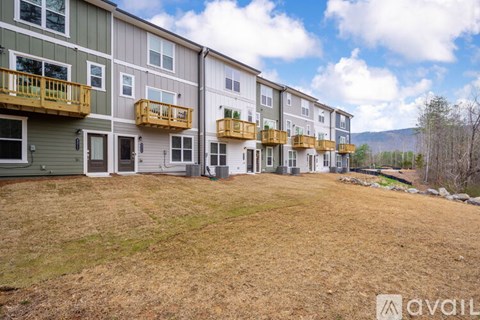 A row of multi-story apartment buildings with balconies.