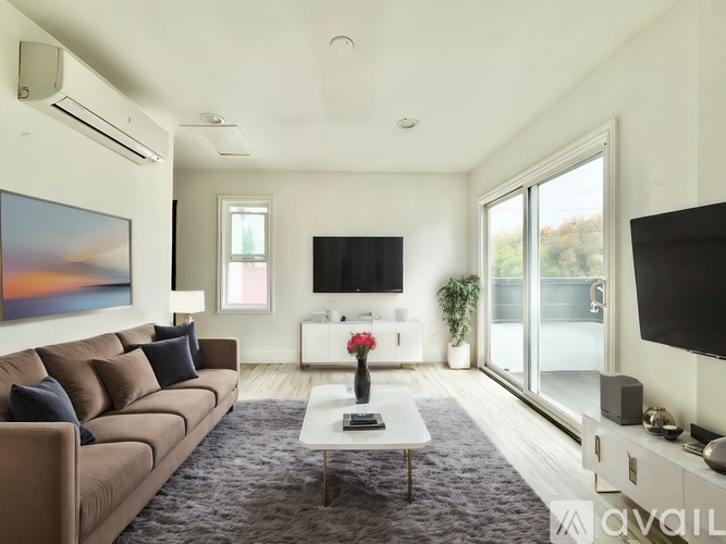 A modern living room with a brown sofa and a large painting on the wall.