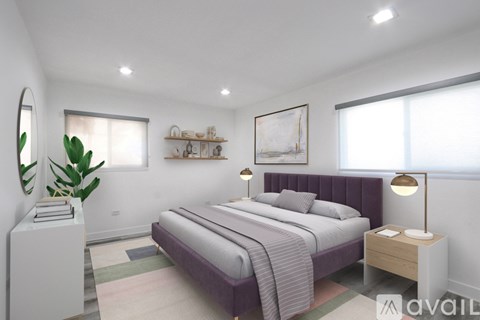 A bedroom with a large bed, a nightstand, and a plant.