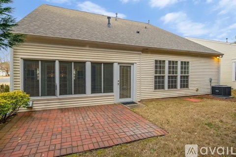 A house with a brick walkway in front.
