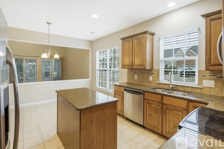 A kitchen with wooden cabinets and a granite countertop.