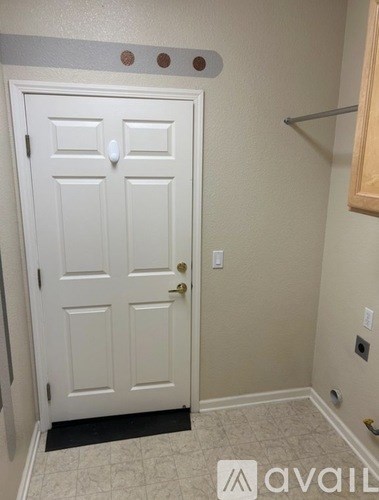 A white door with a black mat in front of it.