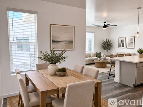 A dining room with a wooden table and chairs.