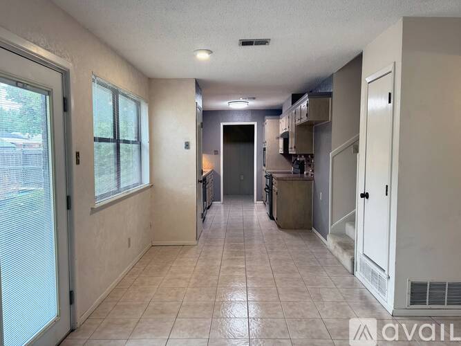 A kitchen area with a counter and cabinets.