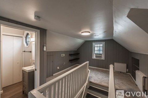 A bedroom with a window and a bed.