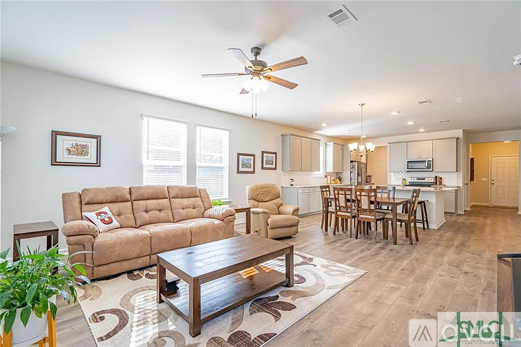 A living room with a brown couch and a wooden coffee table.