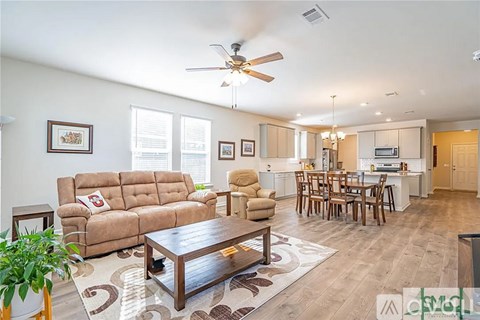 A living room with a brown couch and a wooden coffee table.