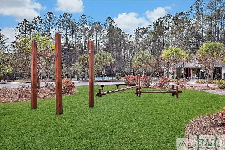 A playground with a swing set and a slide in a grassy area.