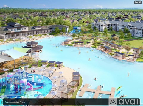 A large outdoor swimming pool with a water slide and a water park.