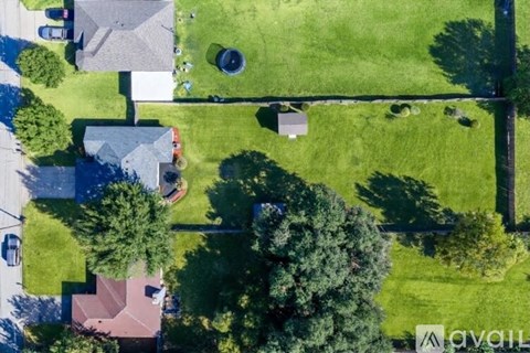 A bird's eye view of a residential area with houses and trees.