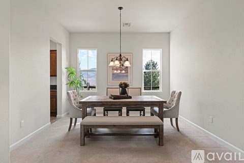 A dining room with a wooden table and chairs.