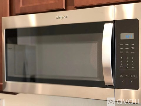A Whirlpool microwave with a digital display and control panel.