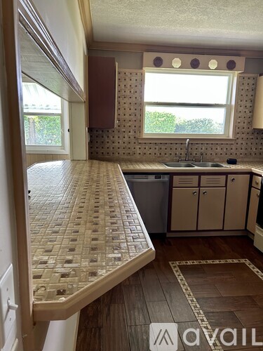 A kitchen with a window and a sink.