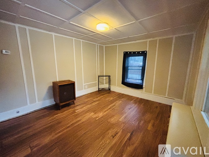 A room with wooden floors and a television set.
