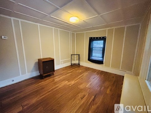A room with wooden floors and a television set.