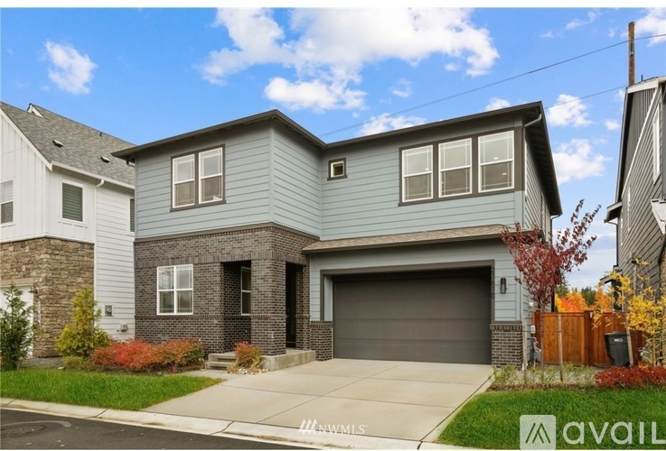 A two-story house with a garage is for sale.